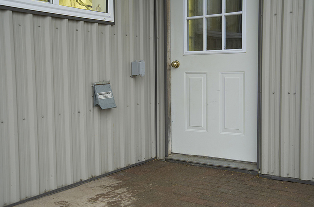 door and wall with milk transfer hose opening