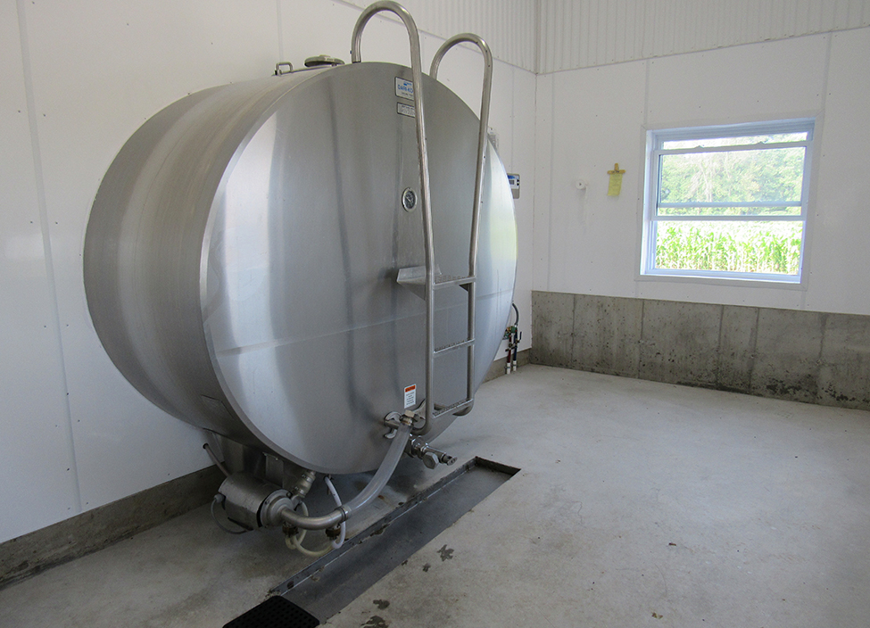 stainless steal bulk tank extending through a wall