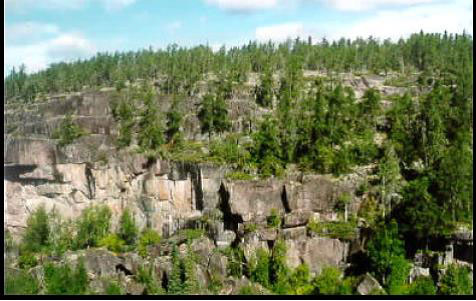 colour photo of two significant cliffs located north of the largest, unnamed, headwater lake within the reserve.
