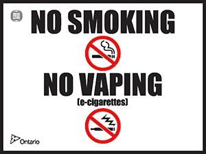 The words “NO SMOKING” over an illustration of a black cigarette with smoke coming out of it in a red circle with a line through it and the words “NO VAPING” above an illustration of a black e-cigarette with vapour coming out of it in a red circle with a line through it. Branded with Ontario and Smoke-Free Ontario logos.